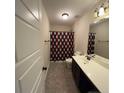 Bathroom featuring neutral color scheme, single sink vanity, and shower with patterned curtain at 94 Red Coat Dr, Cameron, NC 28326