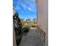 View from the side of the house revealing a manicured yard and nearby residential street at 94 Red Coat Dr, Cameron, NC 28326