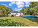 Expansive backyard featuring a lush lawn, above-ground pool, and inviting pergola at 940 Lakeridge Dr, Cameron, NC 28326