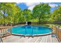 Inviting above-ground pool with deck and ladder, surrounded by lush greenery at 940 Lakeridge Dr, Cameron, NC 28326