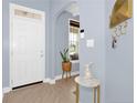 Inviting entryway with neutral walls, hardwood floors, white front door, and a decorative side table at 148 Huzzas Cir, Cameron, NC 28326