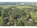 Aerial view of home nestled within lush forest, near a tranquil lake, providing privacy and serenity at 8042 Royal Dr, Sanford, NC 27332