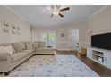Cozy living room with a sectional sofa, neutral paint, ceiling fan, and French doors at 291 Gallery Dr # 102, Spring Lake, NC 28390