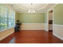 Spacious dining room with hardwood floors, a modern chandelier, and large windows at 34 Coswell Ct, Cameron, NC 28326
