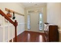 Welcoming entryway featuring hardwood floors and a staircase with a wooden railing at 34 Coswell Ct, Cameron, NC 28326