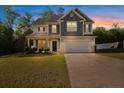 Beautiful home with a two-car garage and an inviting front porch at sunset at 34 Coswell Ct, Cameron, NC 28326