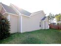 Side exterior view showcasing neutral siding and green lawn at 223 Angel Oak Dr, Bunnlevel, NC 28323