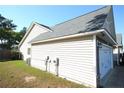 Side exterior view highlighting the siding, roofing, and attached garage at 223 Angel Oak Dr, Bunnlevel, NC 28323