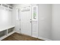 Bright foyer with a built-in bench, coat hooks, and windowed front door, complemented by modern flooring at 254 Angel Oak Dr, Bunnlevel, NC 28323