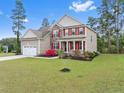 Charming two-story home with a manicured lawn and an attached two-car garage in a lovely neighborhood at 43 Spring Flowers Dr, Cameron, NC 28326