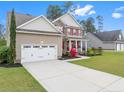 Beautiful two-story home featuring a spacious driveway, well-maintained lawn and attached garage at 43 Spring Flowers Dr, Cameron, NC 28326