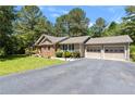 Inviting single-story home with brick and siding, a spacious driveway, and a manicured front lawn at 6044 Saint Andrews Dr, Sanford, NC 27332