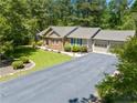 Aerial view of a beautiful brick home, showcasing its well-maintained landscaping and spacious surroundings at 6044 Saint Andrews Dr, Sanford, NC 27332