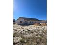 New home under construction, featuring a dark roof and windows with a clear blue sky above at 66 Blackgum Ct, Spring Lake, NC 28390