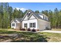Beautiful home featuring white siding, dark shutters, and a well-manicured lawn, showcasing its exterior design at 716 Wildlife Rd, Sanford, NC 27332