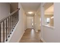 Inviting entryway with hardwood floors, a staircase with iron spindles, and a view into the dining area at 111 Southern Estates Dr, Sanford, NC 27330