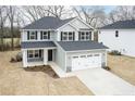 Beautiful two-story home featuring gray siding, black shutters, and an attached two-car garage at 111 Southern Estates Dr, Sanford, NC 27330