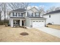 Traditional two-story home with a two-car garage, gray siding and a well-maintained front lawn at 111 Southern Estates Dr, Sanford, NC 27330