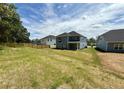Spacious backyard perfect for outdoor activities, featuring a well-maintained lawn and privacy fence at 119 Southern Estates Dr, Sanford, NC 27330