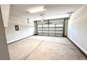 Spacious two-car garage with concrete floors, white walls, and an automatic door at 214 Drayton Hall Ln, Sanford, NC 27330