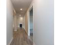 Hallway view featuring wood floors, neutral paint, recessed lighting, and a fireplace at 214 Drayton Hall Ln, Sanford, NC 27330