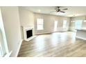 Spacious living room featuring wood floors, a fireplace, and large windows for natural light at 316 Bishop Ln, Sanford, NC 27330