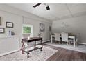 Neutral painted dining room offers hardwood floors, a fireplace, and updated lighting fixture, with access to other rooms at 413 Lincoln Mckay Dr, Lillington, NC 27546