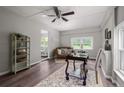 Bright home office boasts hardwood floors, neutral paint, a decorative fireplace, and access to another room at 413 Lincoln Mckay Dr, Lillington, NC 27546