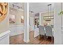 Elegant dining room featuring stylish lighting, hardwood floors, and a neutral color palette at 439 Colonist Pl, Cameron, NC 28326