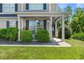 Inviting front porch with hanging plants and meticulously maintained landscaping at 439 Colonist Pl, Cameron, NC 28326