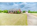 Beautiful brick home with a detached garage and long driveway, offering ample space and privacy at 2021 Rice Rd, Sanford, NC 27330