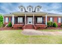Inviting brick home with a covered front porch and well-maintained landscaping, perfect curb appeal at 2021 Rice Rd, Sanford, NC 27330