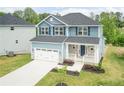 Lovely home boasting a well-maintained lawn, a garage, and tasteful landscaping at 303 Bishop Ln, Sanford, NC 27330
