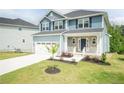 Beautiful two-story home showcasing a manicured lawn, stone accents, and a driveway at 303 Bishop Ln, Sanford, NC 27330