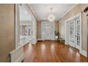 Elegant foyer featuring hardwood floors, beautiful front door, decorative lighting, and classic architectural details at 116 Hawthorne Rd, Raleigh, NC 27605