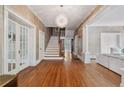 Elegant foyer with hardwood floors, staircase, decorative chandelier, and classic architectural details at 116 Hawthorne Rd, Raleigh, NC 27605