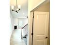 Welcoming entryway featuring hardwood floors, staircase, and view of the living room at 156 Southern Estates Dr, Sanford, NC 27330
