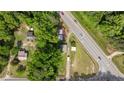 Aerial view of a property showing the home, surrounding trees, and proximity to the road at 3042 Overhills Rd, Bunnlevel, NC 28323