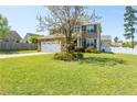 Attractive home showcasing a lush green lawn, complemented by mature trees and a fenced yard at 37 Annapolis Rd, Cameron, NC 28326
