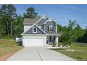 Lovely two-story home with a spacious driveway and a well-maintained lawn at 500 Lionheart Ln, Sanford, NC 27330