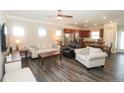 Spacious living room with hardwood floors and open floor plan to kitchen and dining areas at 500 Lionheart Ln, Sanford, NC 27330