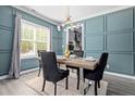 Dining room with blue walls, a wooden table with four black chairs, and gray carpet at 65 Alder Dr, Cameron, NC 28326
