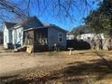 Rear of home with screened-in porch and blue exterior siding with a barbecue grill at 713 E Divine St, Dunn, NC 28334