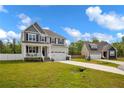 Desirable two-story home with a charming porch, two-car garage, and long driveway, set in a nice neighborhood at 761 Burley Oak Dr, Cameron, NC 28326