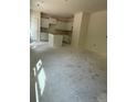 Spacious kitchen area awaiting customization, featuring white cabinets and a central island space at 136 Baneberry Pl, Broadway, NC 27505