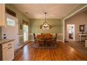 Inviting dining room with wood floors, wainscoting, and stylish chandelier at 199 Courtney Ln, Dunn, NC 28334