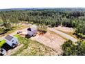 Expansive aerial view showcasing new home construction on a wooded lot; a serene, private setting at 940 Allstar Ave, Cameron, NC 28326