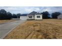 New construction home with a two-car garage, covered front porch, and spacious front yard at 180 Cedar Wind Ln, Fuquay Varina, NC 27526