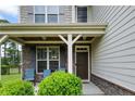 Cozy front porch showcases stone accents and comfortable seating for relaxing at 852 Micahs N Way, Spring Lake, NC 28390