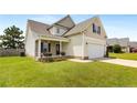 Well-manicured lawn, covered porch, and two-car garage, enhancing its curb appeal at 110 Wynngate Dr, Cameron, NC 28326